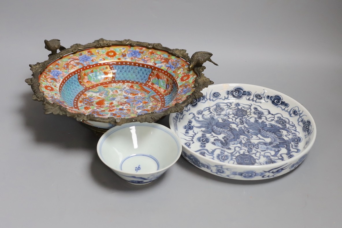 A Chinese clobbered dish with bronze mount, a Chinese blue-and-white Buddhist lion dish and a blue and white landscape bowl, 18th century and later